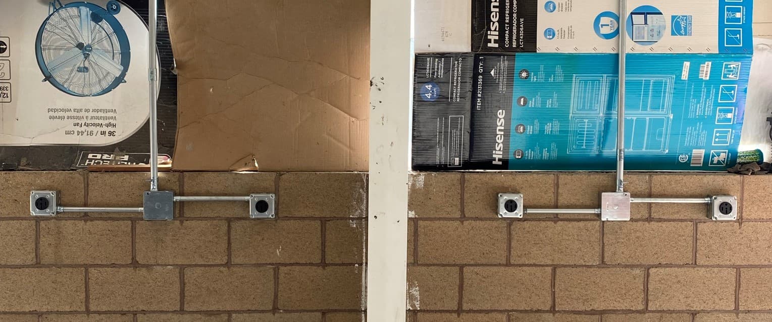 Commercial wall with conduit and electrical panels