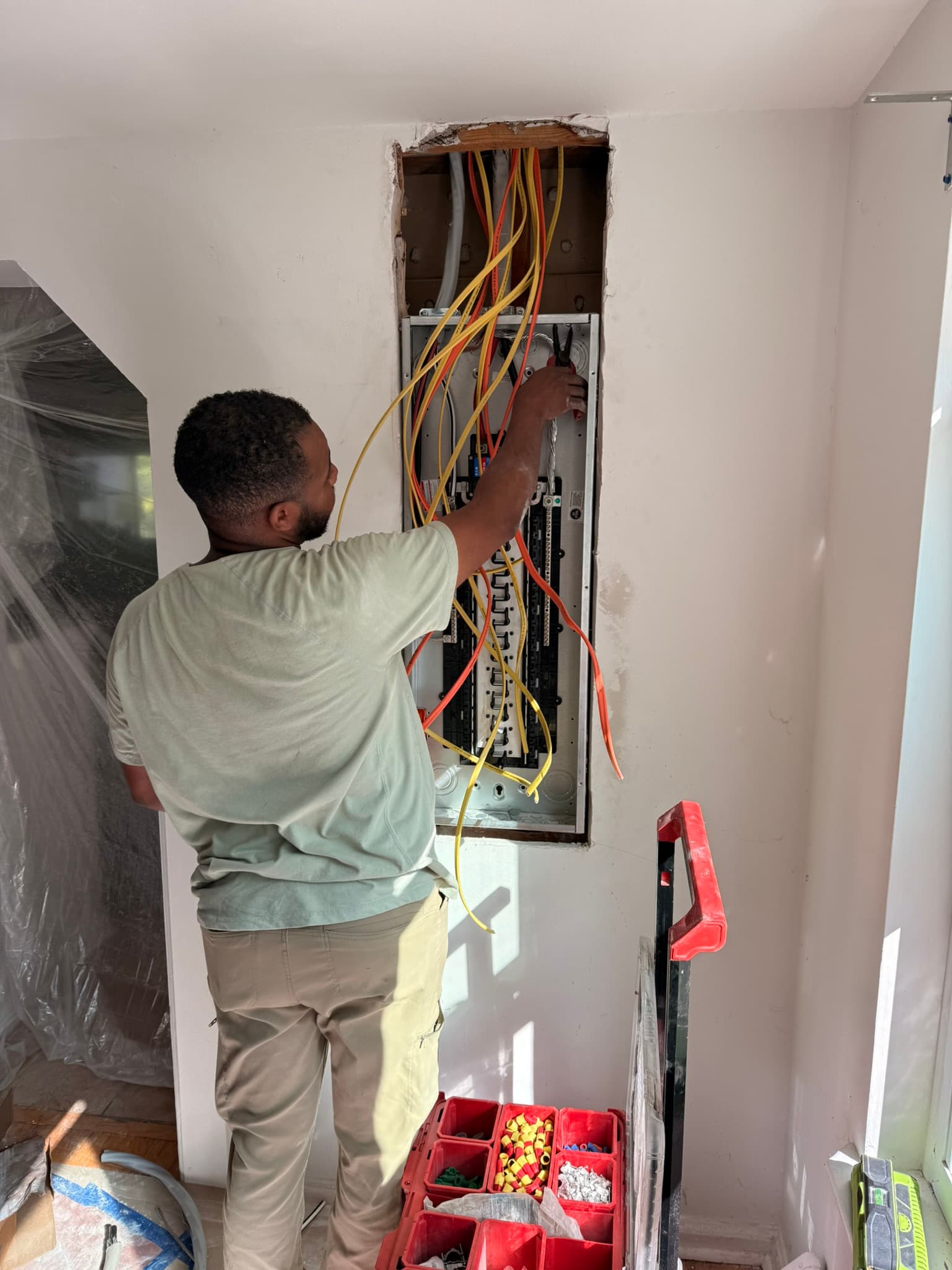 Dexter working on the wiring of the new 200 Amp panel inside with plenty of space for future additions.